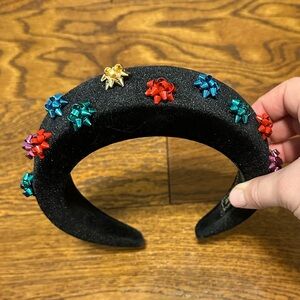 Black velveteen headband with small, colorful package bows